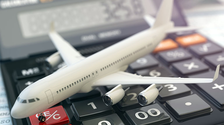 Toy airplane sitting across a calculator