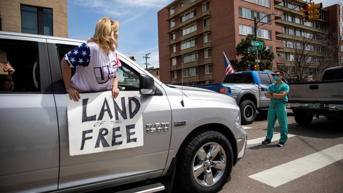 A health care worker stands in a Denver street on April 19 to &lt;a href=&quot;https://www.cnn.com/2020/04/20/us/coronavirus-colorado-health-care-trnd/index.html&quot; target=&quot;_blank&quot;&gt;counterprotest&lt;/a&gt; the hundreds of people who were demanding that stay-at-home orders be lifted.