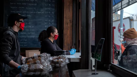 Volunteers serve free lunch at a Bronx pub